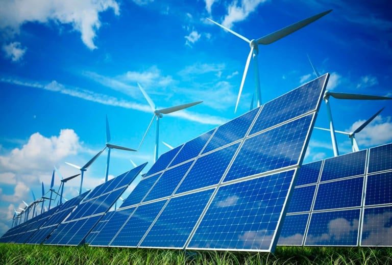 A picture of solar panels and wind turbines in a field.