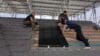 Viridian solar panels being installed on the roof of a house.