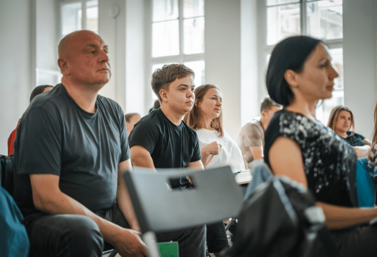 Group of people taking notes in a room