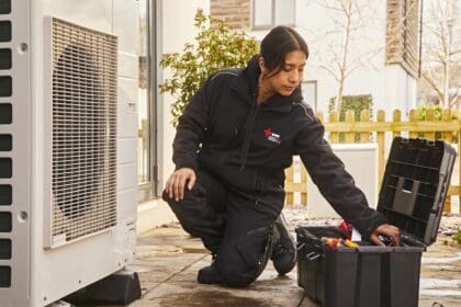 Female installer working on a heat pump
