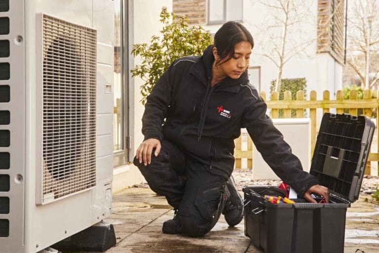 Female installer working on a heat pump