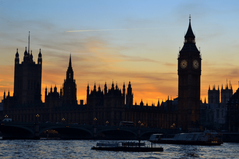 Houses of parliament silhouettes against the sunset horizon