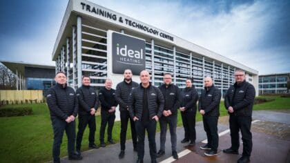 A group of men standing outside the Ideal HEating training centre building.
