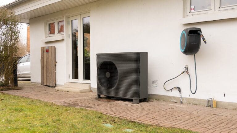 An Aira heat pump outside a house.