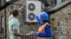 Female construction worker and client looking at house