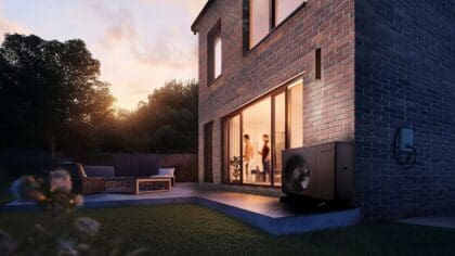 Navien heat pump installed outside house at sunrise