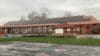 A school building with solar panels on the roof.