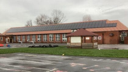A school building with solar panels on the roof.