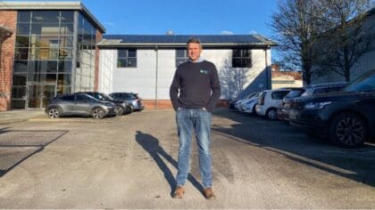 A man is photographed standing outside a building.