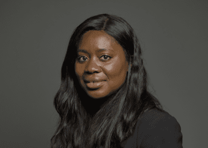 Woman with black skin and long hair on black background