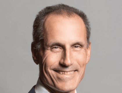 Middle aged man in grey suit and tie