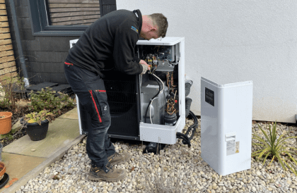 man fitting heat pump
